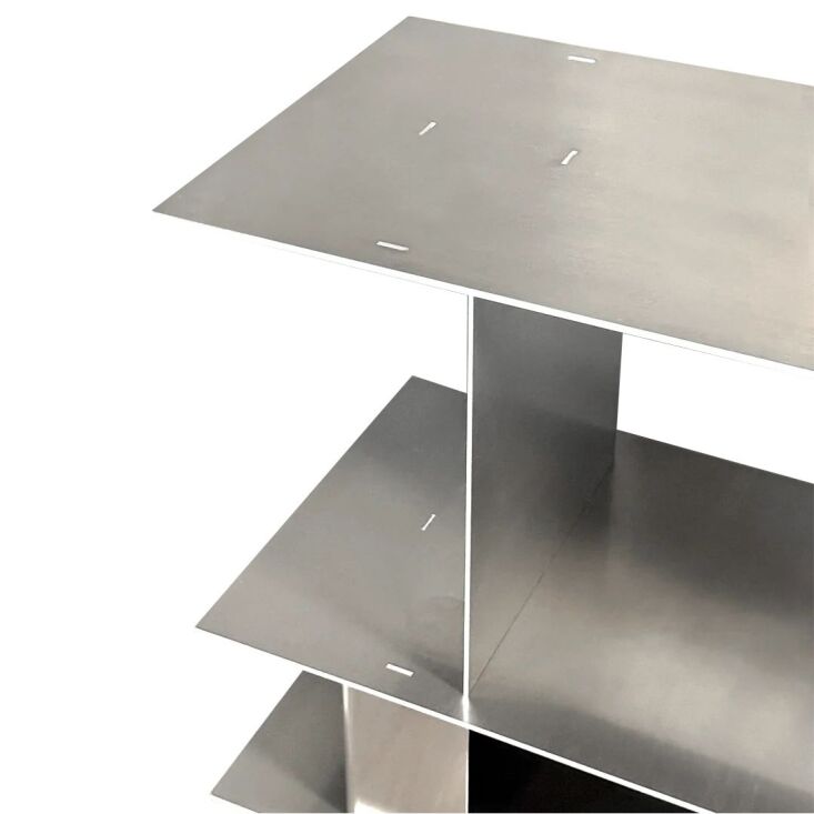 Close-up of interlocking raw aluminum shelving components.