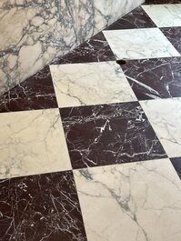 Large-scale marble checkerboard flooring in a contemporary home setting.