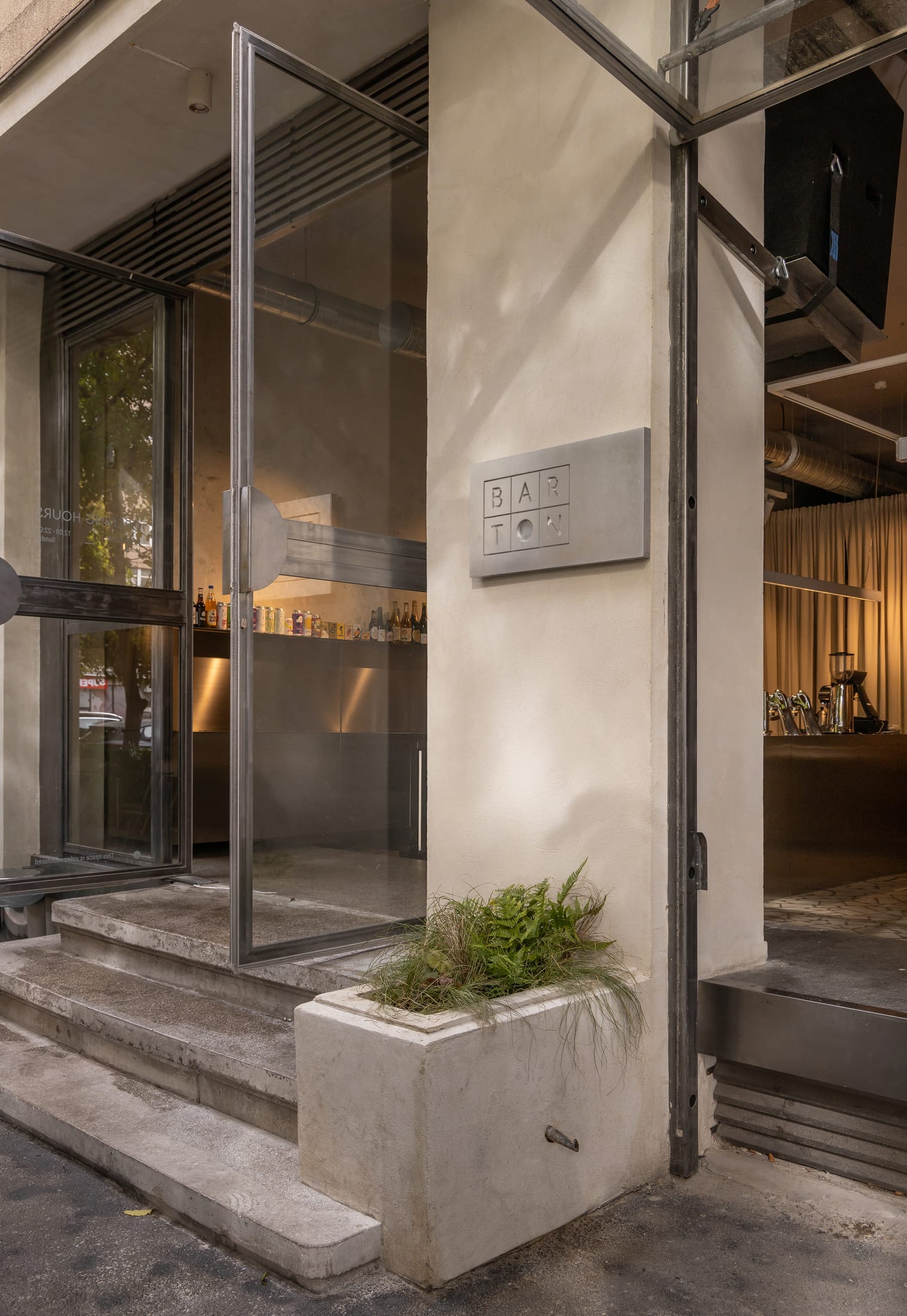 Interior shot highlighting the original 1950s concrete columns repurposed as spatial dividers.
