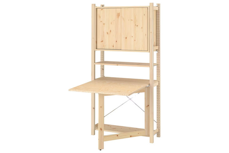 The Ikea Ivar natural pine foldable table integrated with a larger wall storage unit.