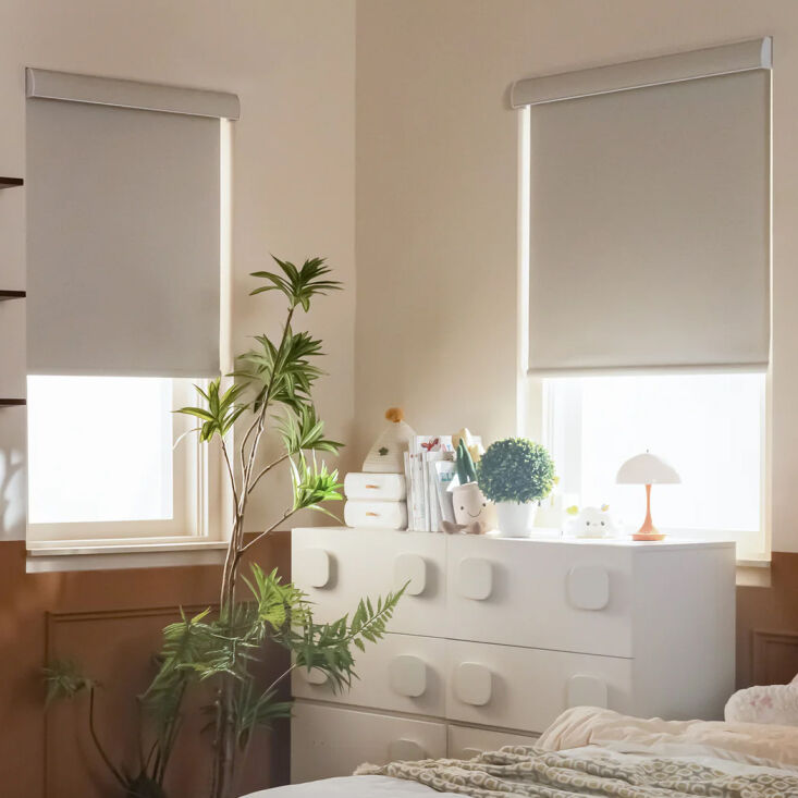 Motorized blackout roller shades featuring side rail tracks for automated light control.