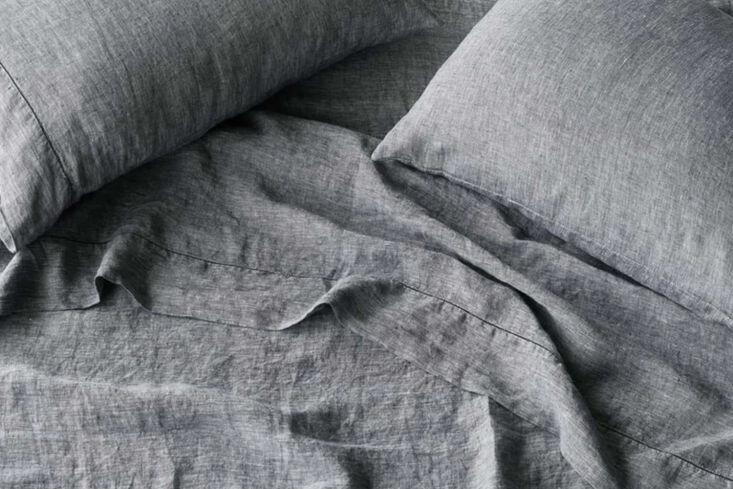 A set of stonewashed linen sheets in various natural earth tones.