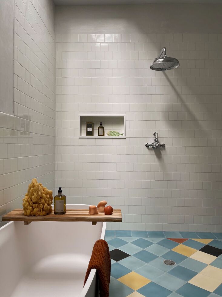 Bathroom featuring harlequin-patterned cement floor tiles and a minimalist design.