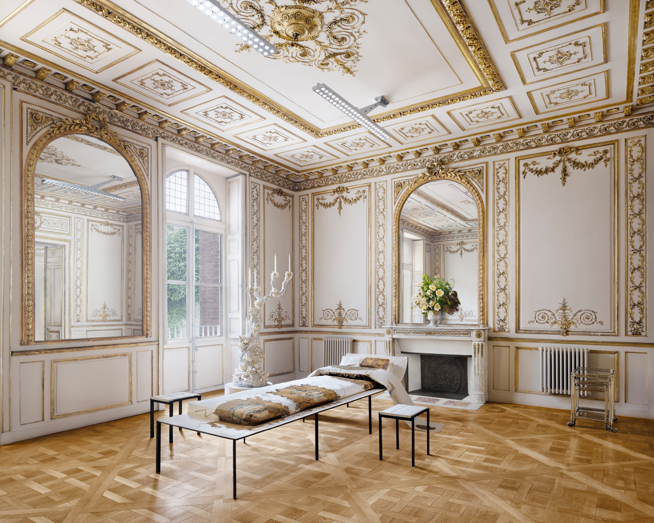 A minimalist office setup with modern partitions inserted into a raw, aged industrial space.