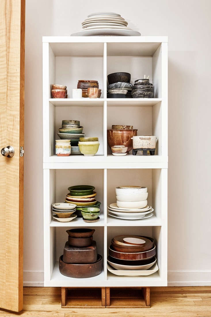 The kitchen of David Tanis featuring low-tech shelving and a curated collection of soulful ceramics.
