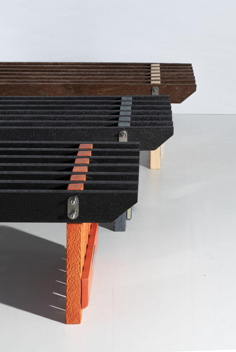 Three Torii benches in black, brown, and orange color profiles arranged in a minimalist studio setting.