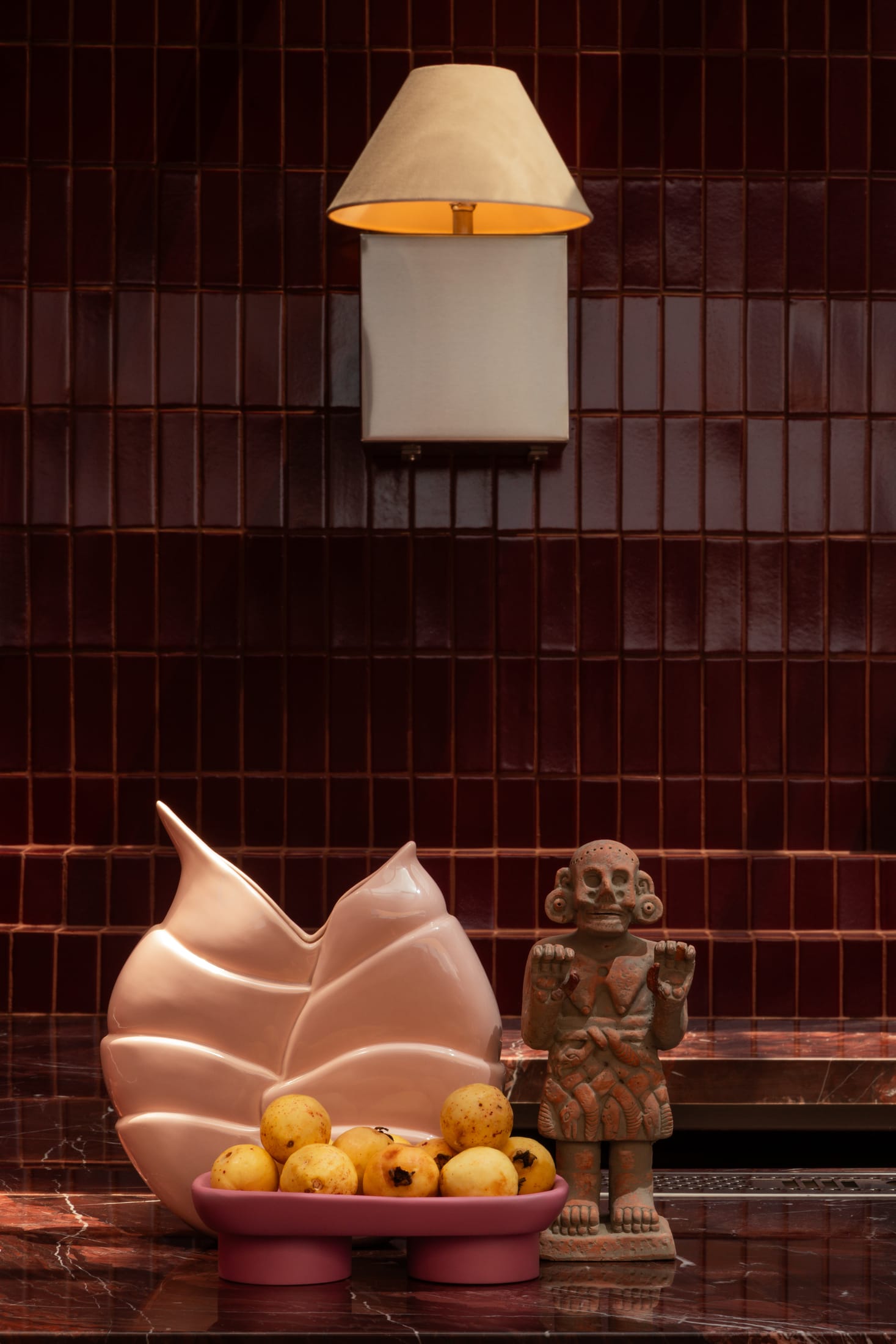 Interior shot of Tonana bar with warm red lighting and textured walls.