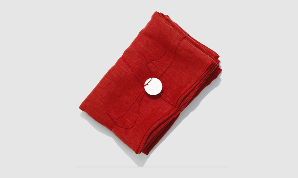 A pair of red-on-red Tomato linen pillowcases from Madre, showcasing tone-on-tone stitching.