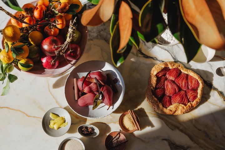 A poached pear crostata showing the flaky texture of a baked olive oil crust.