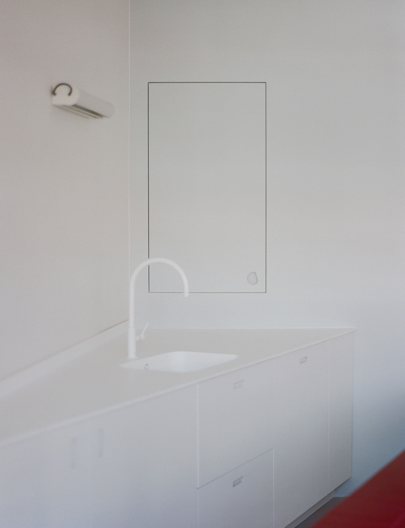 View of the office and studio space featuring a minimalist desk and shelving.