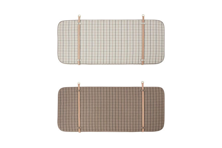 The Oyoy Grid Headboard mounted on a wall with a distinct quilted grid pattern.
