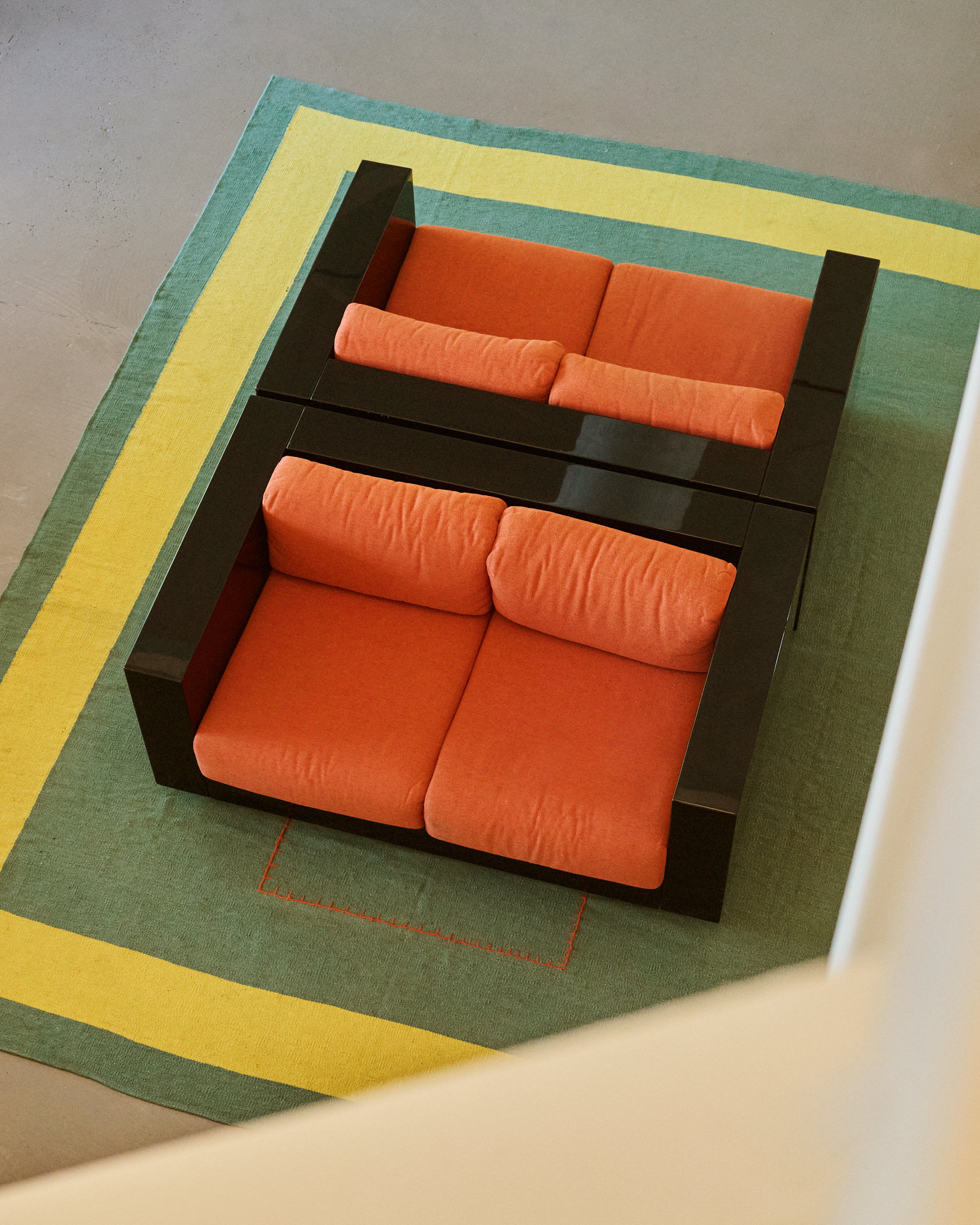 A bright showroom area within the office featuring clothing racks and heritage windows.