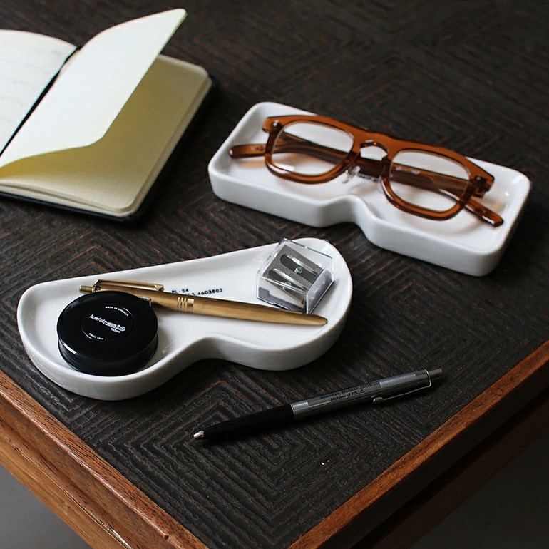 Puebco ceramic trays repurposed to hold small household items and stationery.