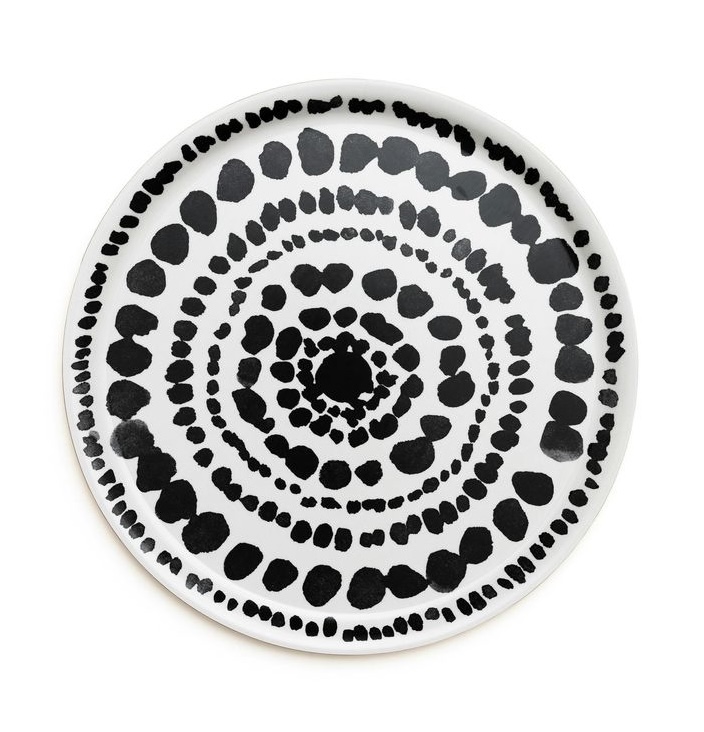 A circular birch tray with a black and white minimalist geometric pattern from Desenio Home.