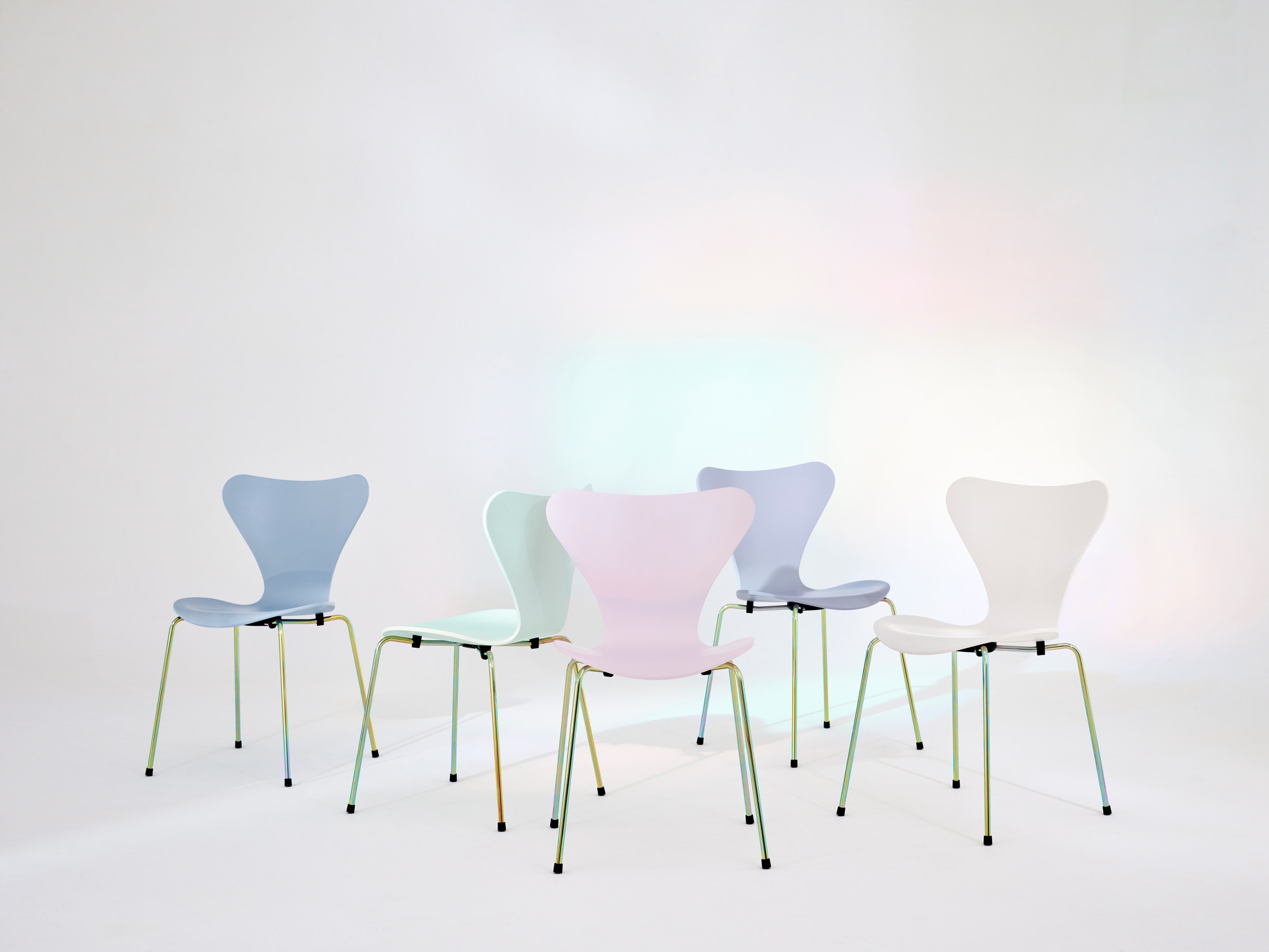 An arrangement of Series 7 chairs in a minimalist interior setting.