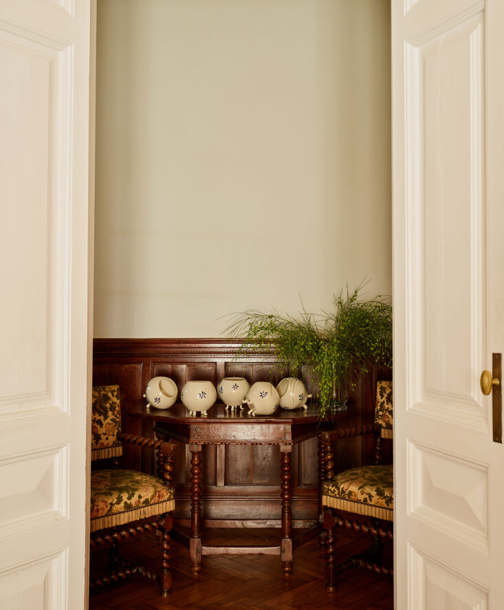 Hand-painted ceramic vases from Barcelona positioned next to antique French XIII Armchairs.