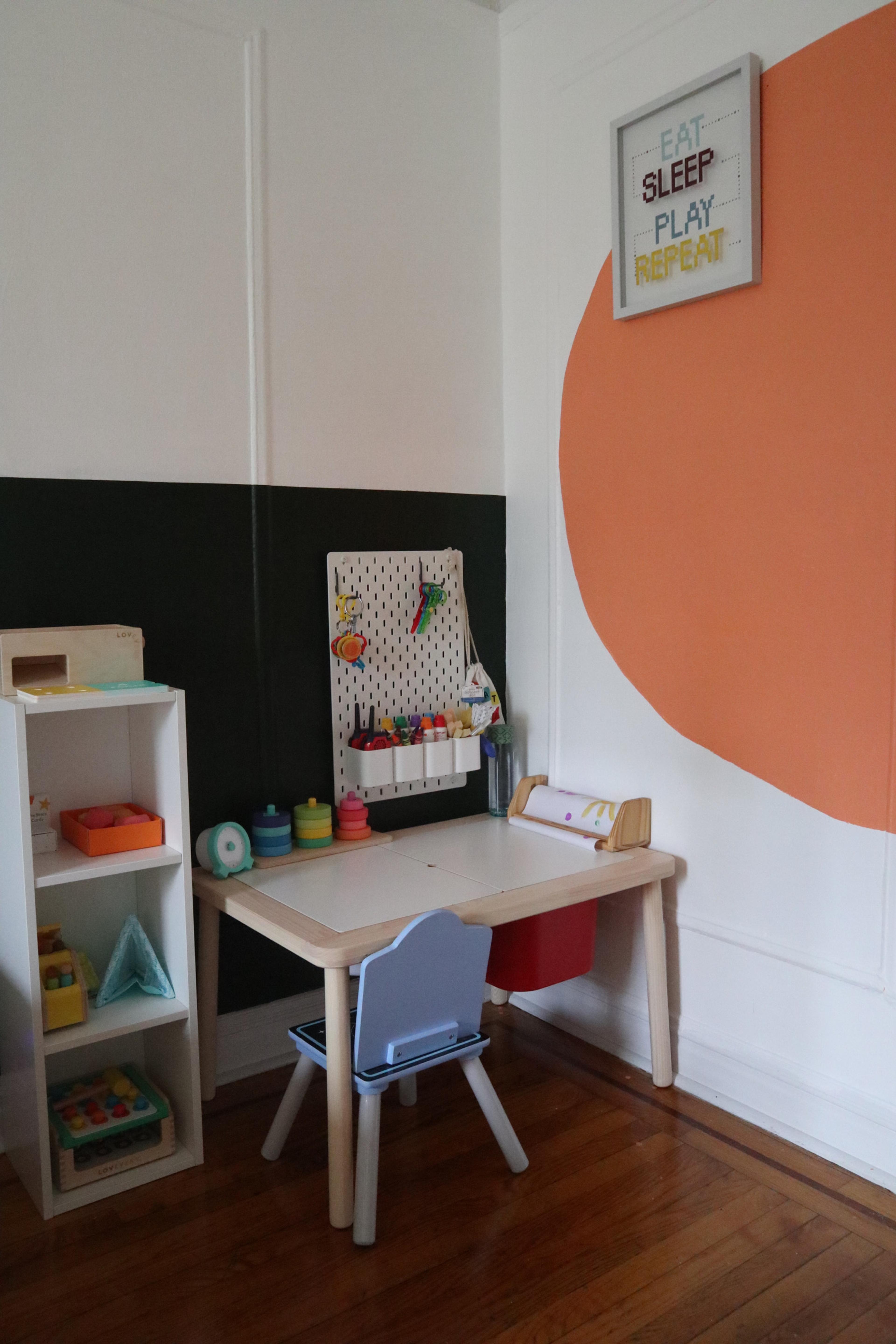 A large, minimalist peach-colored circle painted on a crisp white wall.