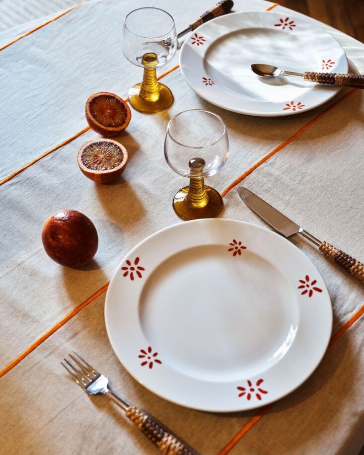 Close-up of cutlery featuring handwoven rattan handles.