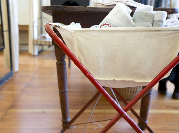 A selection of folded muslin blankets in various patterns and plain white from a boutique source.