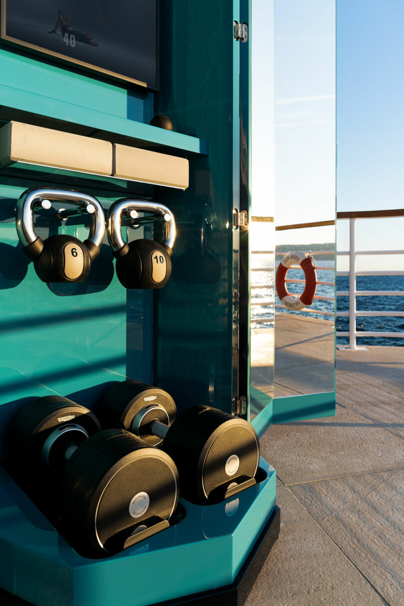 The Ottagono gym system set up on a luxury yacht deck overlooking the ocean.