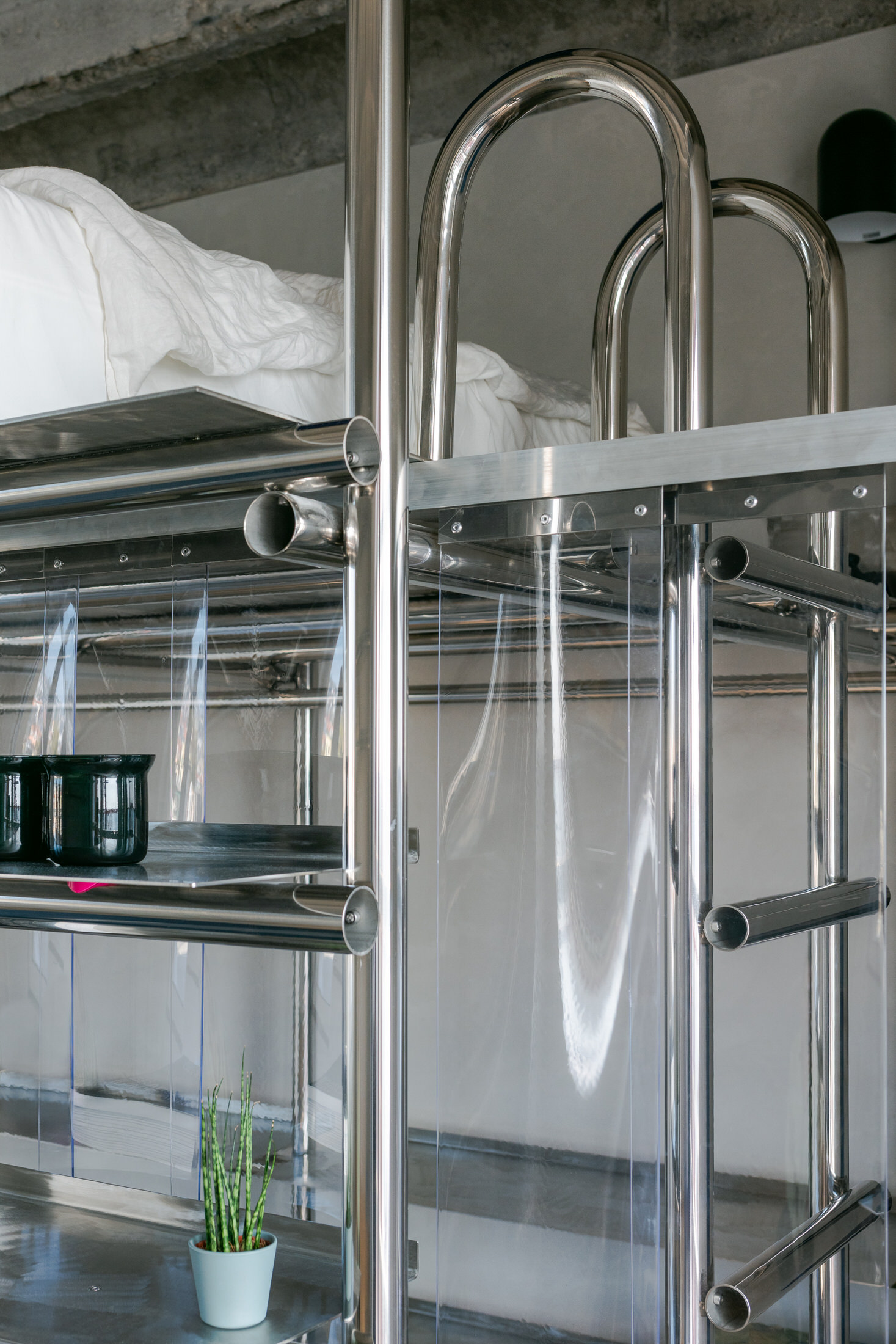 Close-up of the interaction between industrial grey ceilings and warm spruce wood partitions.