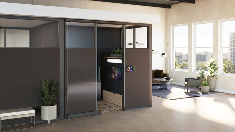 The exterior of a Steelcase and Logitech Ocular View booth situated within an open-plan office environment.
