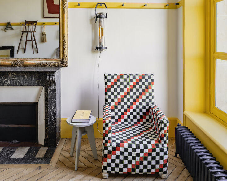 A multi-colored beaded chair used as a statement piece in a historic Paris apartment home office.