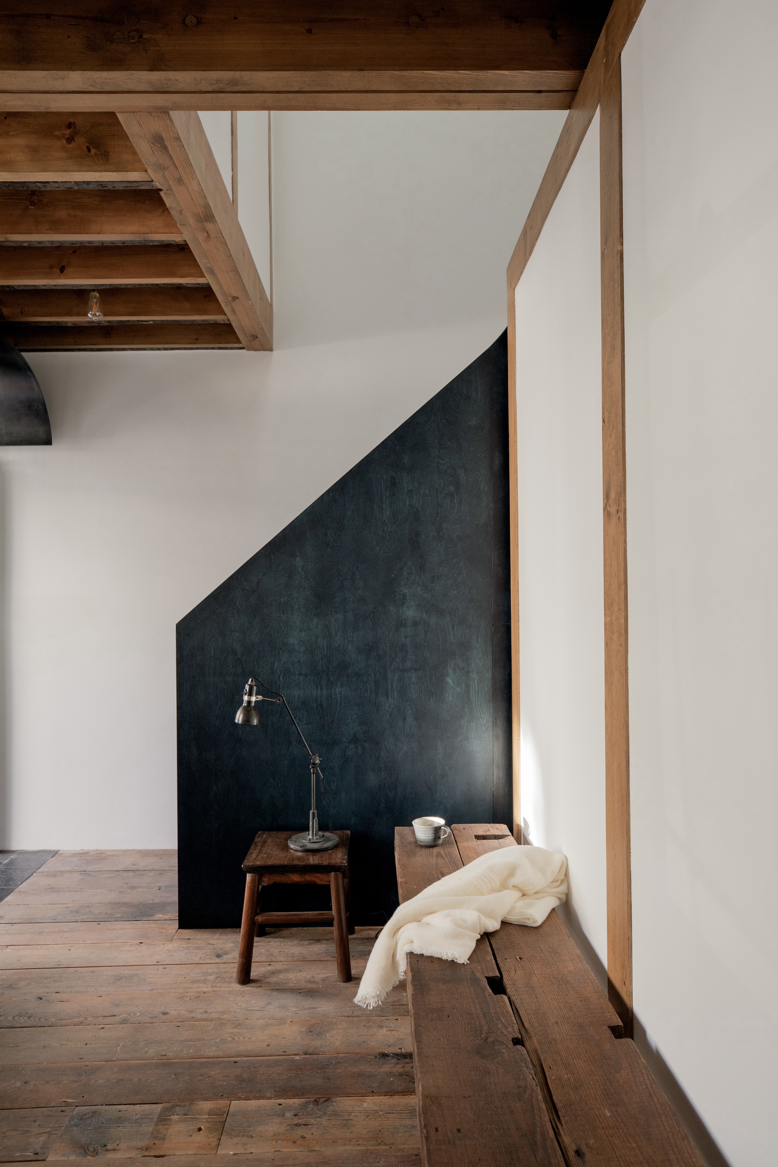 Exposed timber floor joists and roof trusses in a renovated London townhouse.
