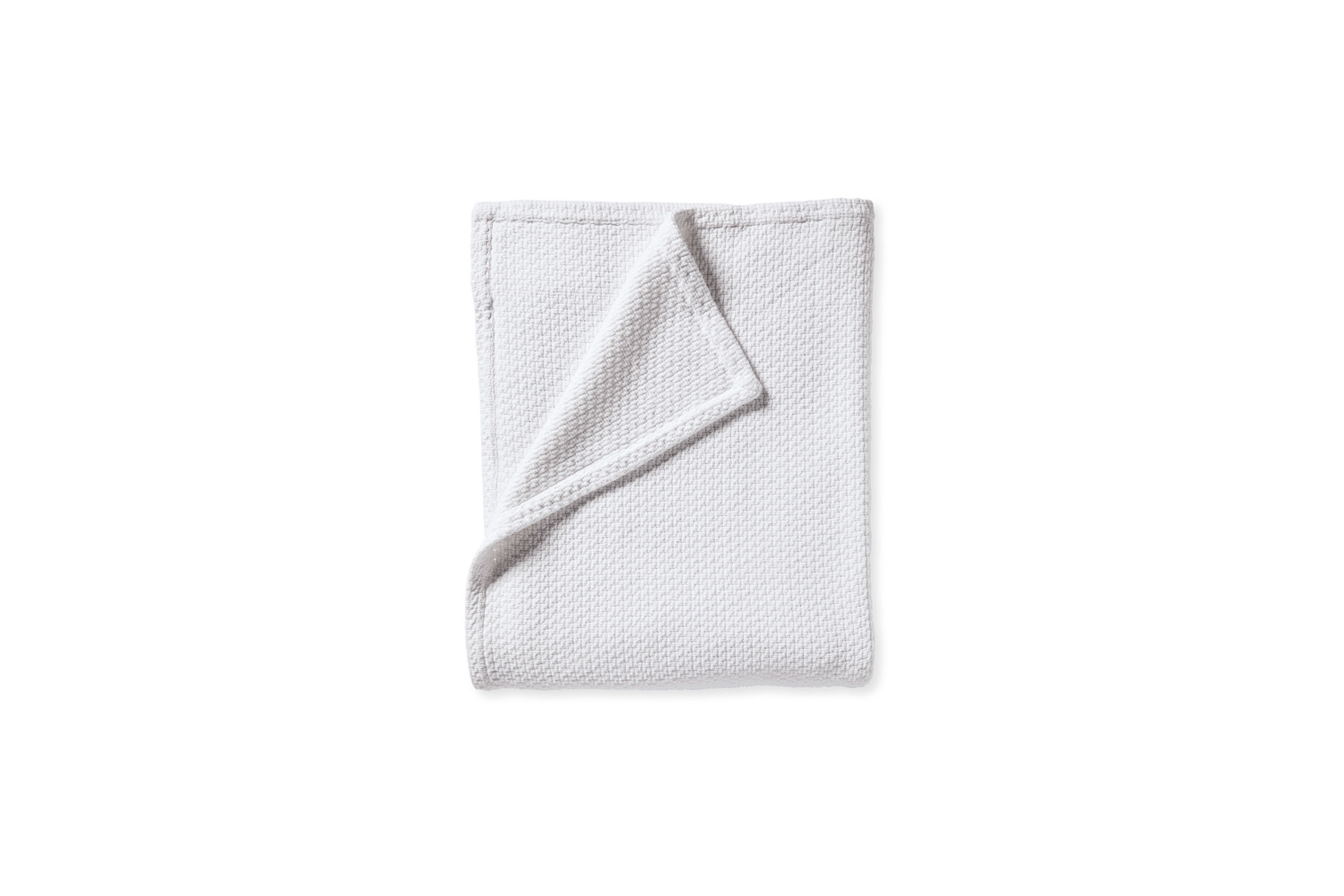 A crisp white Serena and Lily Eastham bed blanket layered on a minimalist bed.