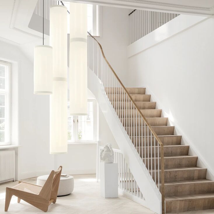 A cylindrical modern pendant light wrapped in acoustic Snowsound fabric.