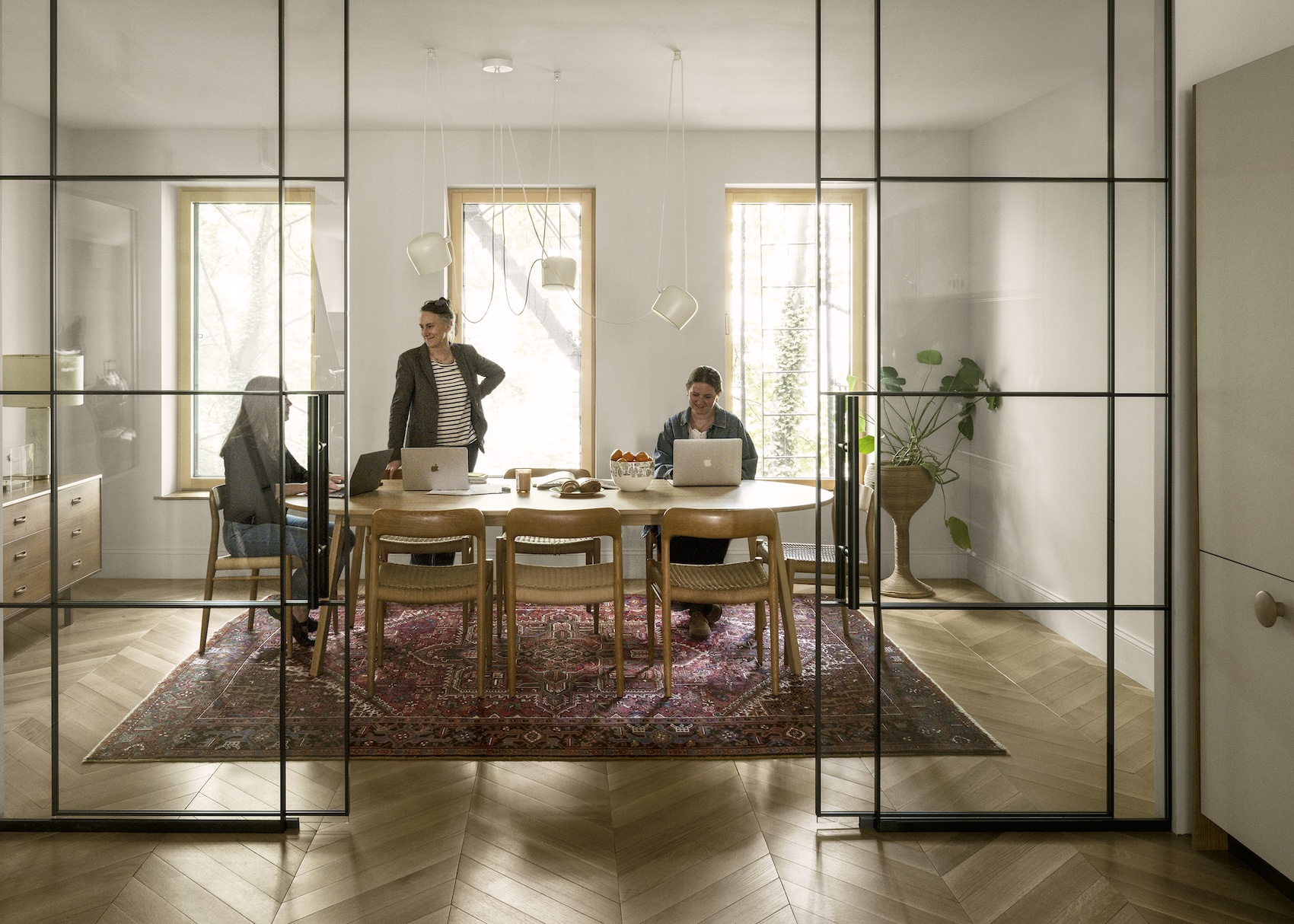 Sophie Demenge and her team in a conference room with glazed partitions.