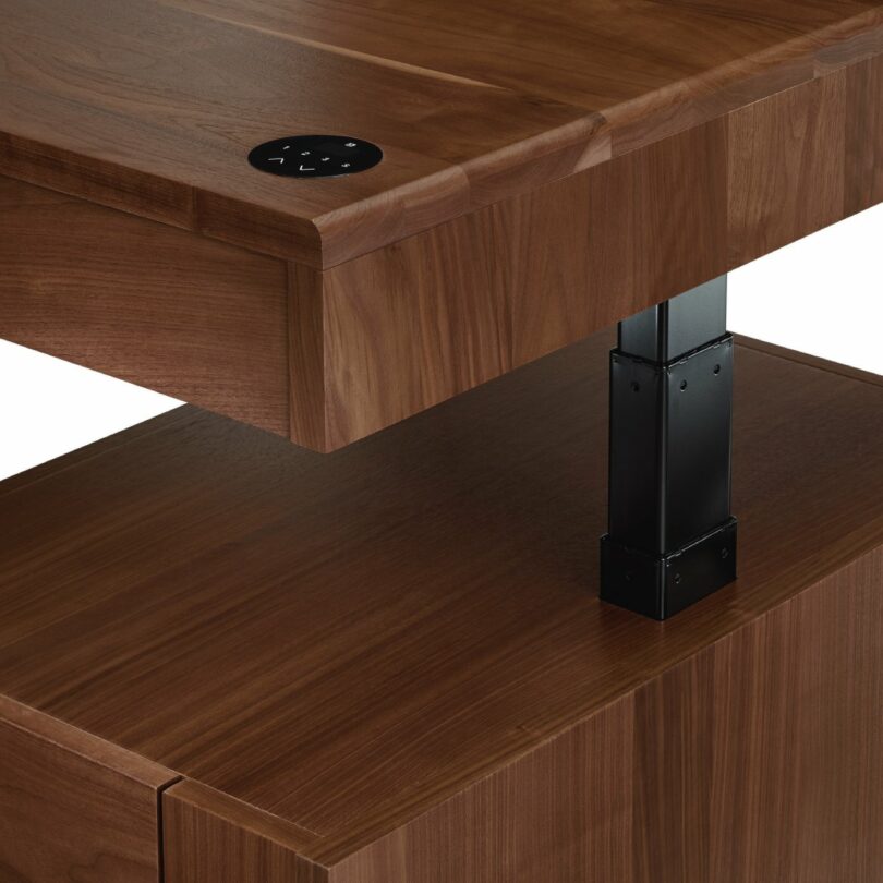 Close-up of the black metal height adjustment mechanism underneath the wooden desk surface.