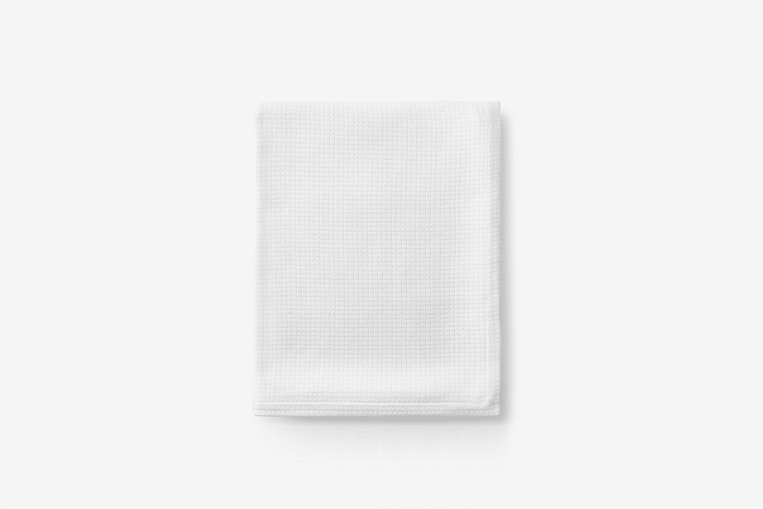 A close-up of a structured cotton weave blanket available in various colors.