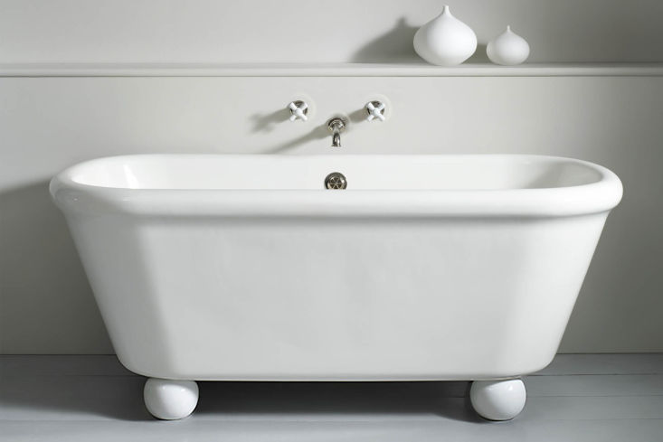 The Rockwell Bath with feet in a minimalist bathroom setting.