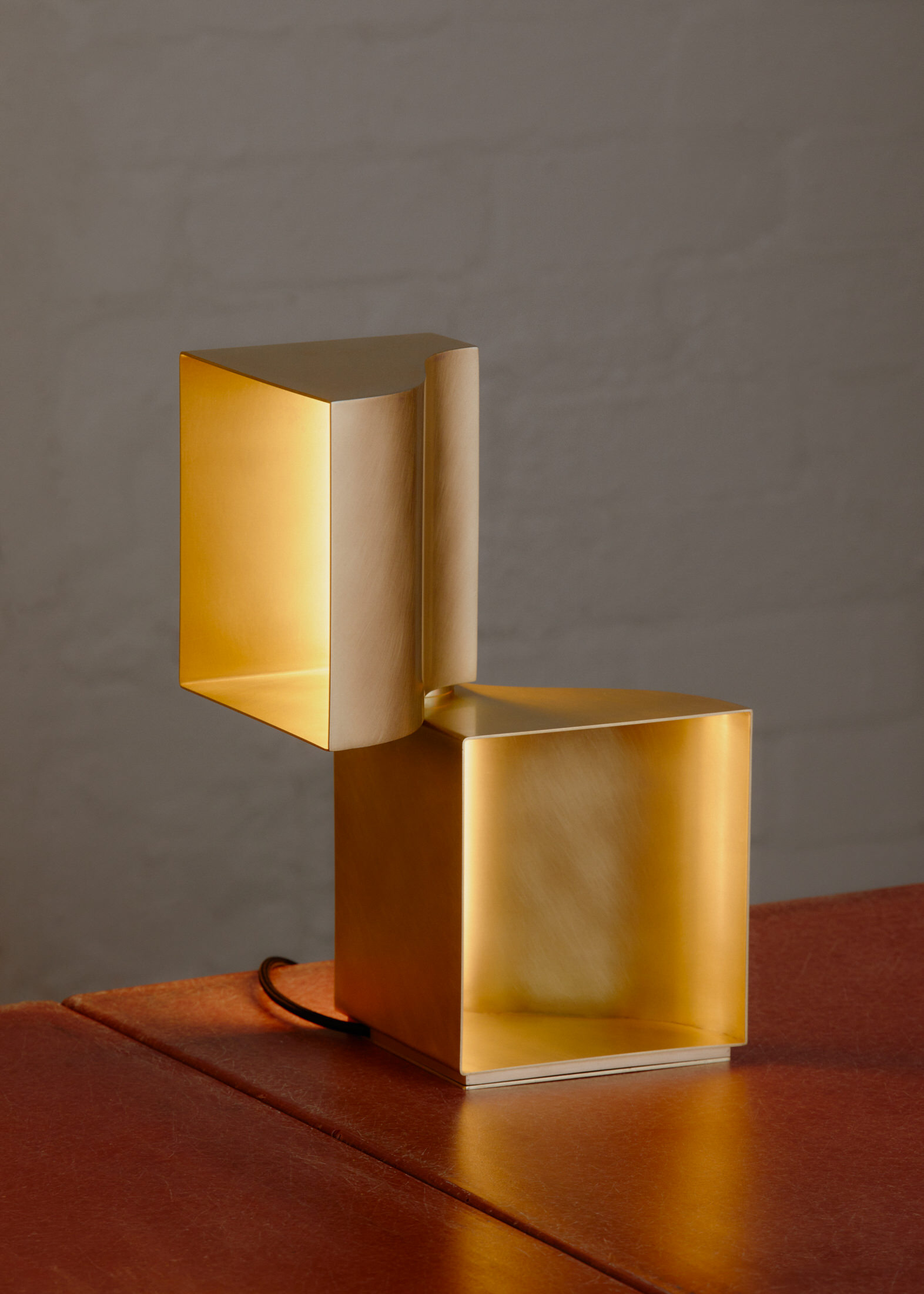 Half Buckle light fixture in aged brass from the Und Messing exhibition.