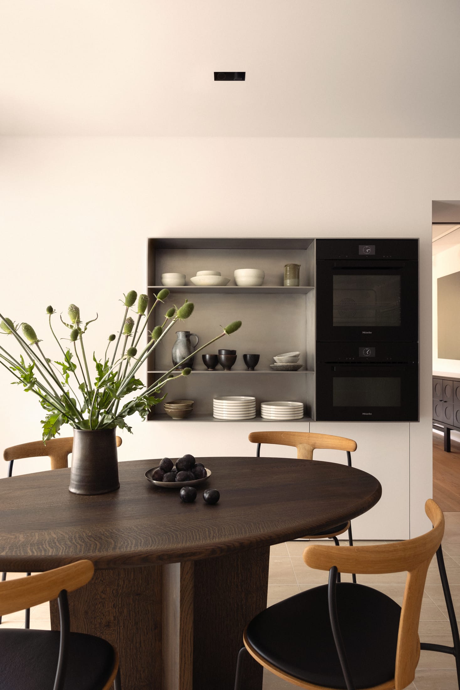 Close-up of travertine textures and matte wood finishes in a bathroom or kitchen setting.