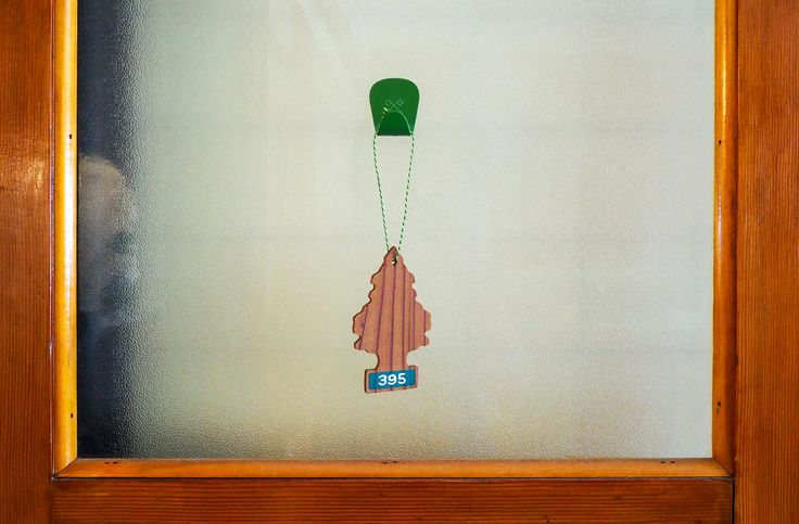 A person carefully removing a hook from a glass surface without leaving residue.