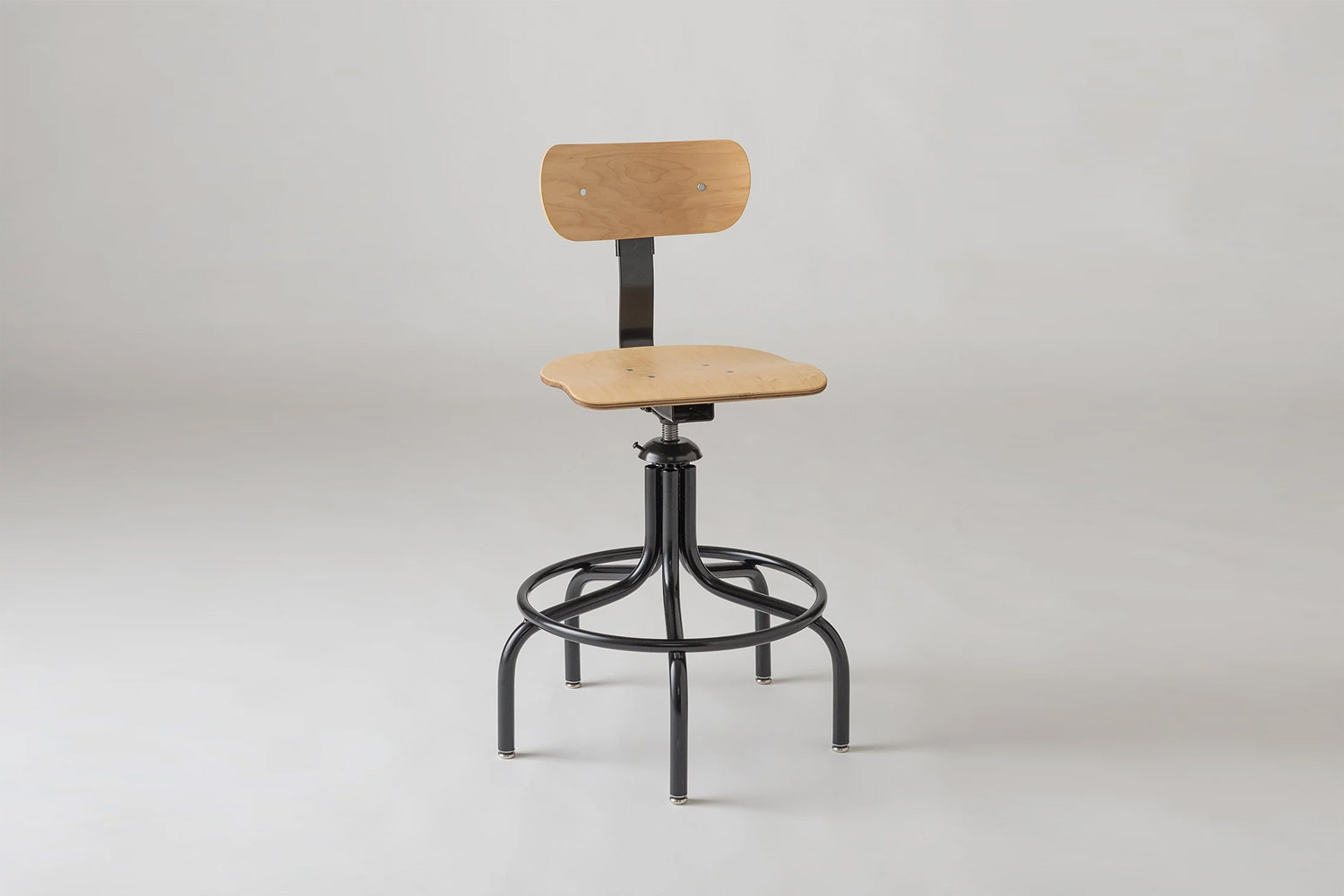A vintage-inspired Schoolhouse Drafting Chair made of iron and wood.