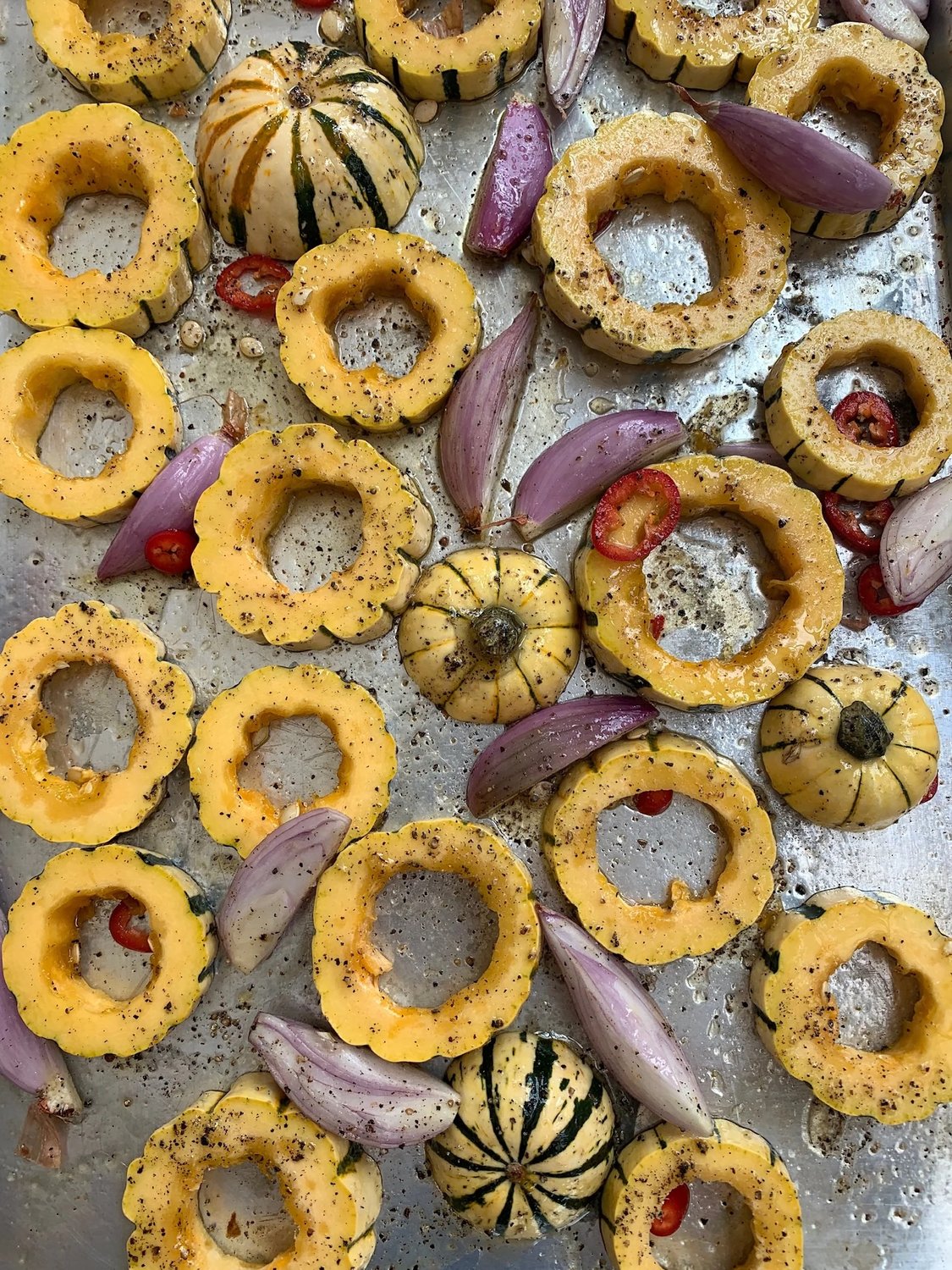 Overhead view of sliced squash prepared for the oven.