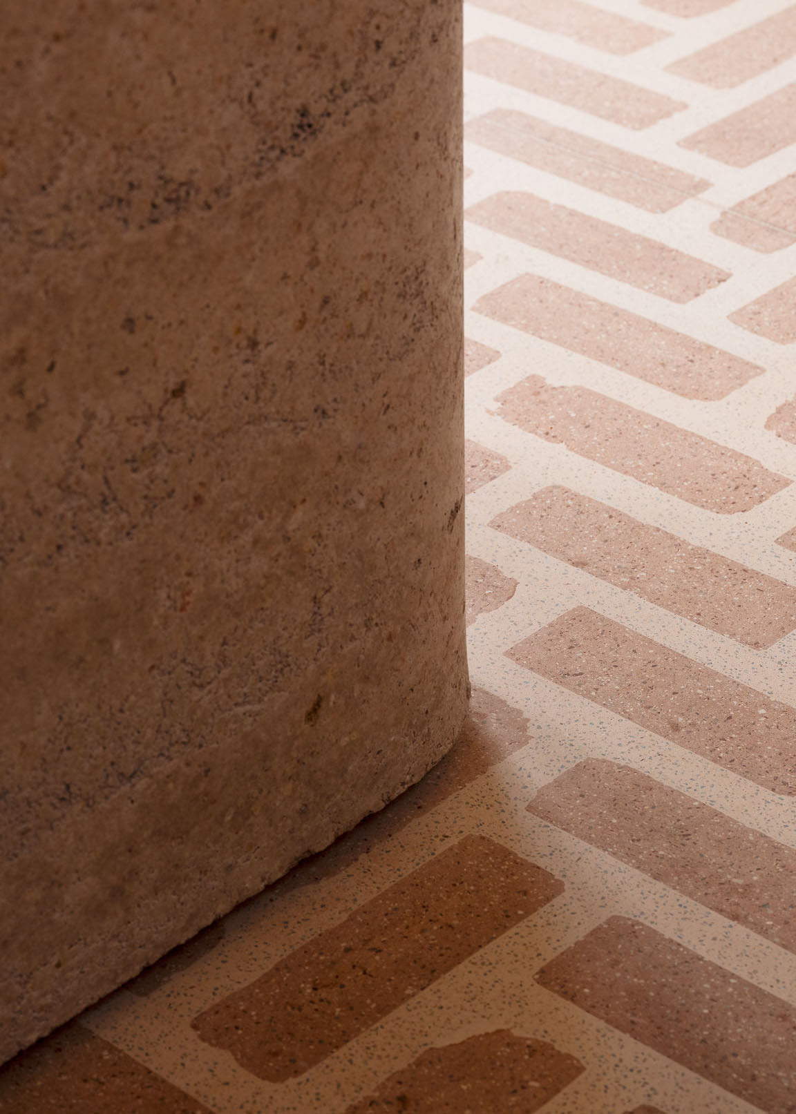 Close-up of the Victorian rammed earth entry plinth and architectural textures.
