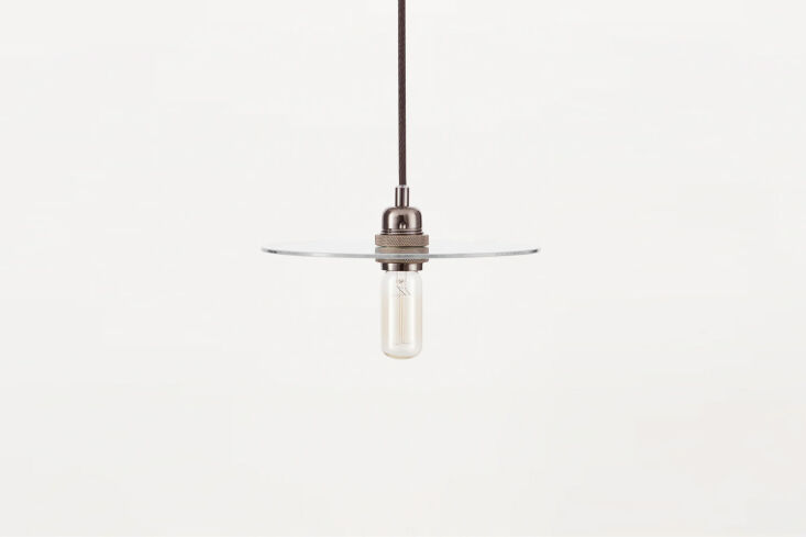 A simple steel and glass disc pendant light with a transparent, clean design.