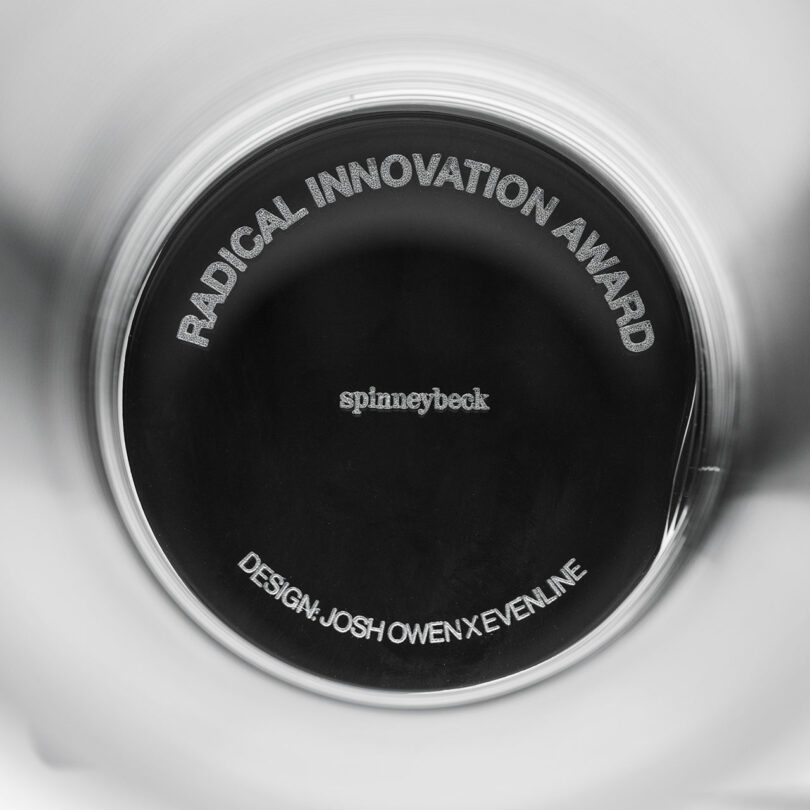 Detailed close-up of a 3D printed glass award plaque with 'RADICAL INNOVATION AWARD' text.