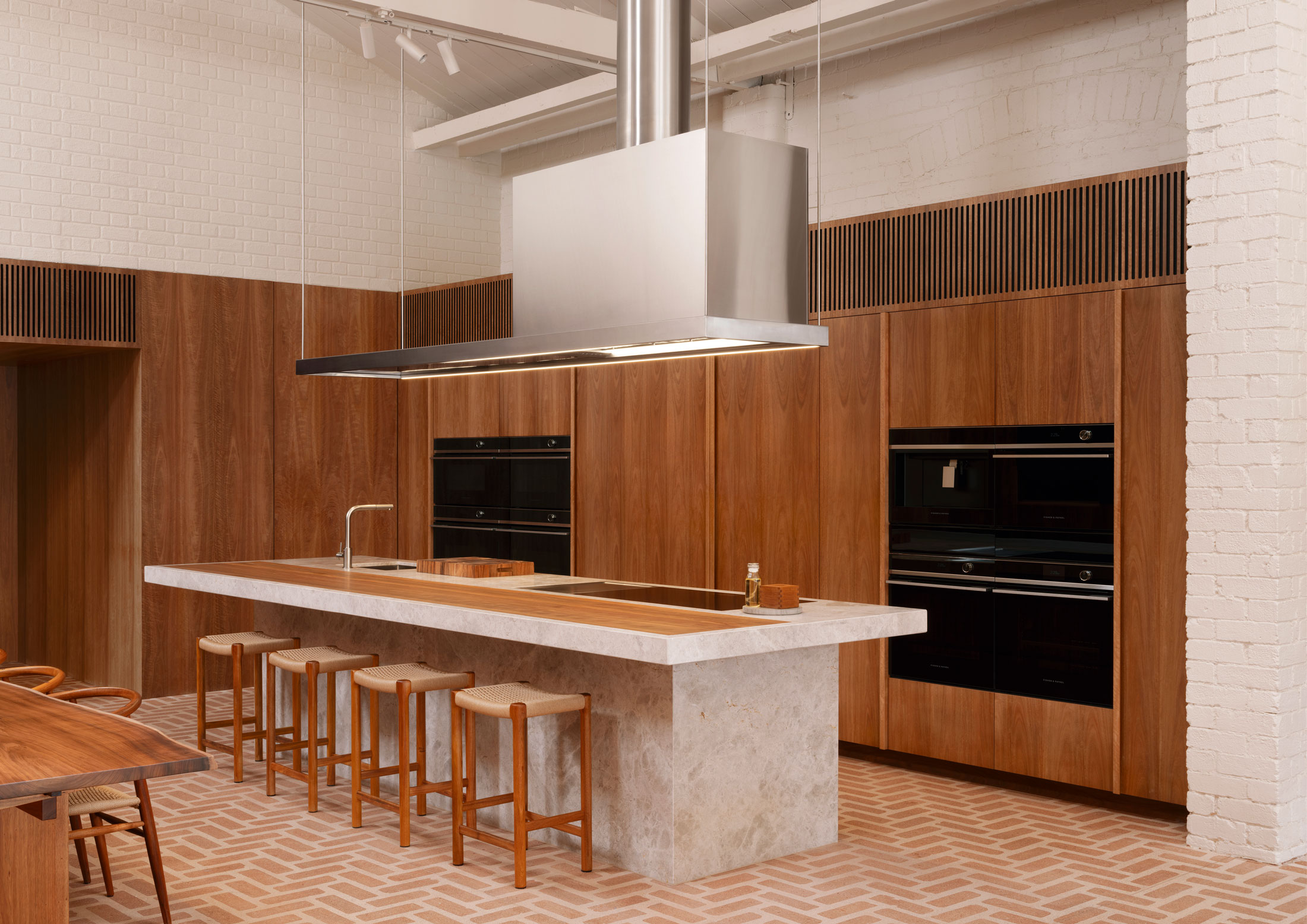 Detailed view of the heritage timber roof trusses and red brick walls inside the Melbourne showroom.
