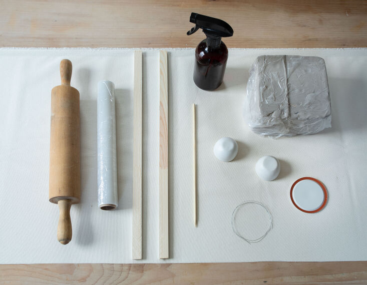 A collection of household items like jars and rolling pins used as pottery tools.