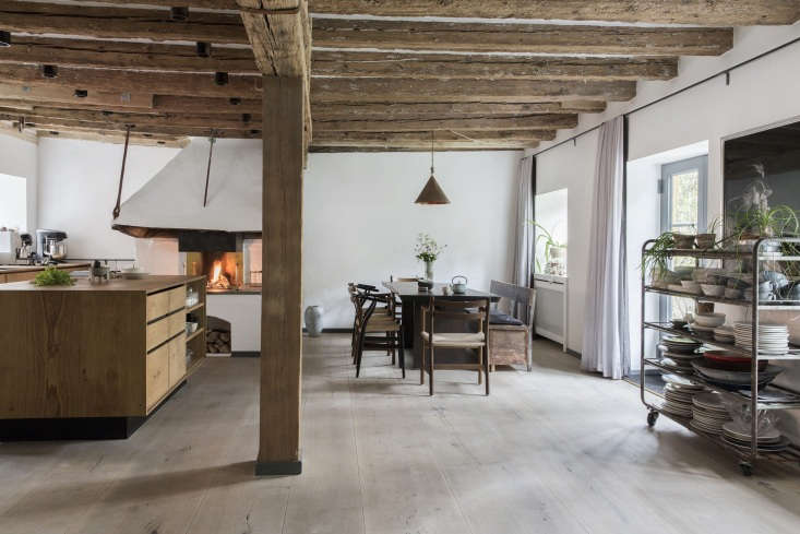 Detailed view of custom Dinesen wood cabinetry and a large kitchen island in a Scandi-style kitchen.