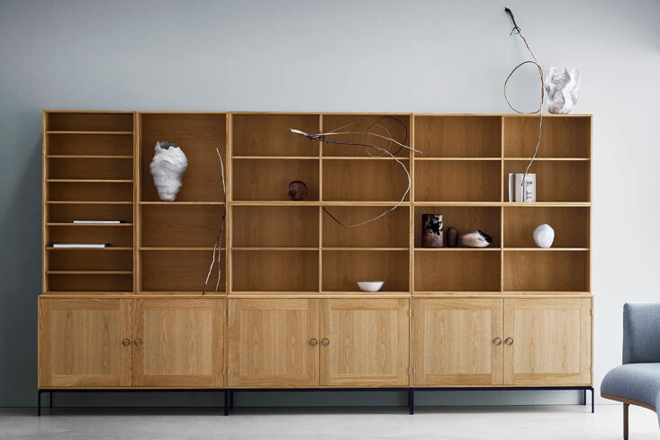 A Carl Hansen & Son FK63 Deep Bookcase in oiled oak against a neutral wall.