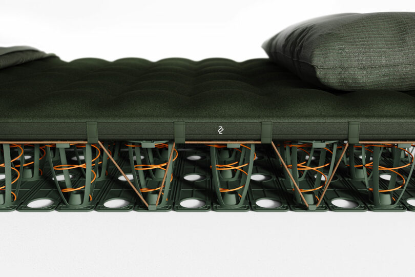 Side view of the MAZZU camping mattress with pillows, showing its thickness and support structure.