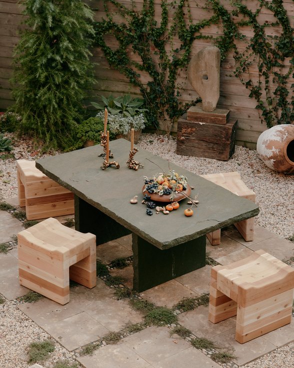 A curated garden space in a Brooklyn townhouse, showing an intimate seating area.
