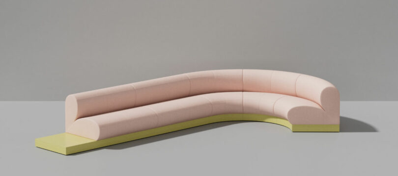 Curved pink modular sofa with a contrasting yellow base.