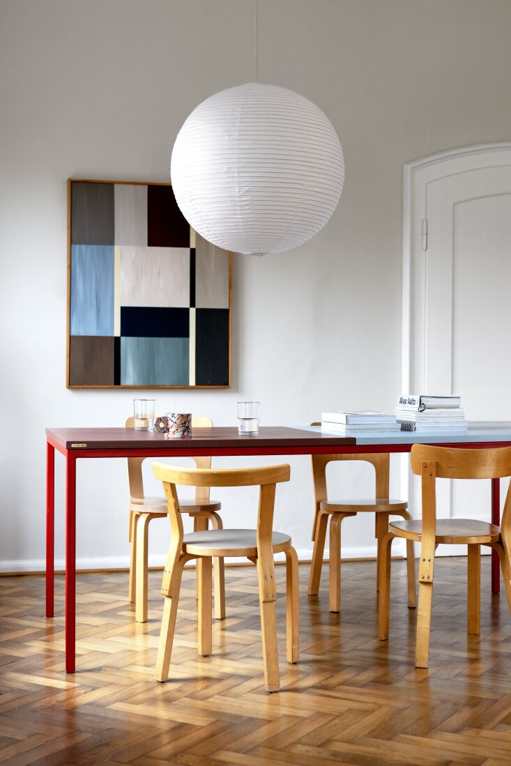 Full view of the Friis X Swantje Hinrichsen dining table in a brightly lit dining room.